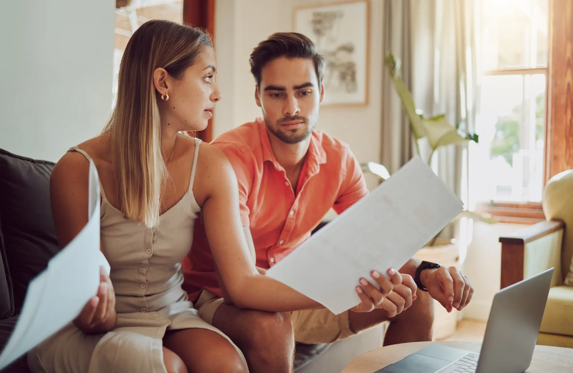 Couple reviewing lease agreement and costs before breaking their rental contract