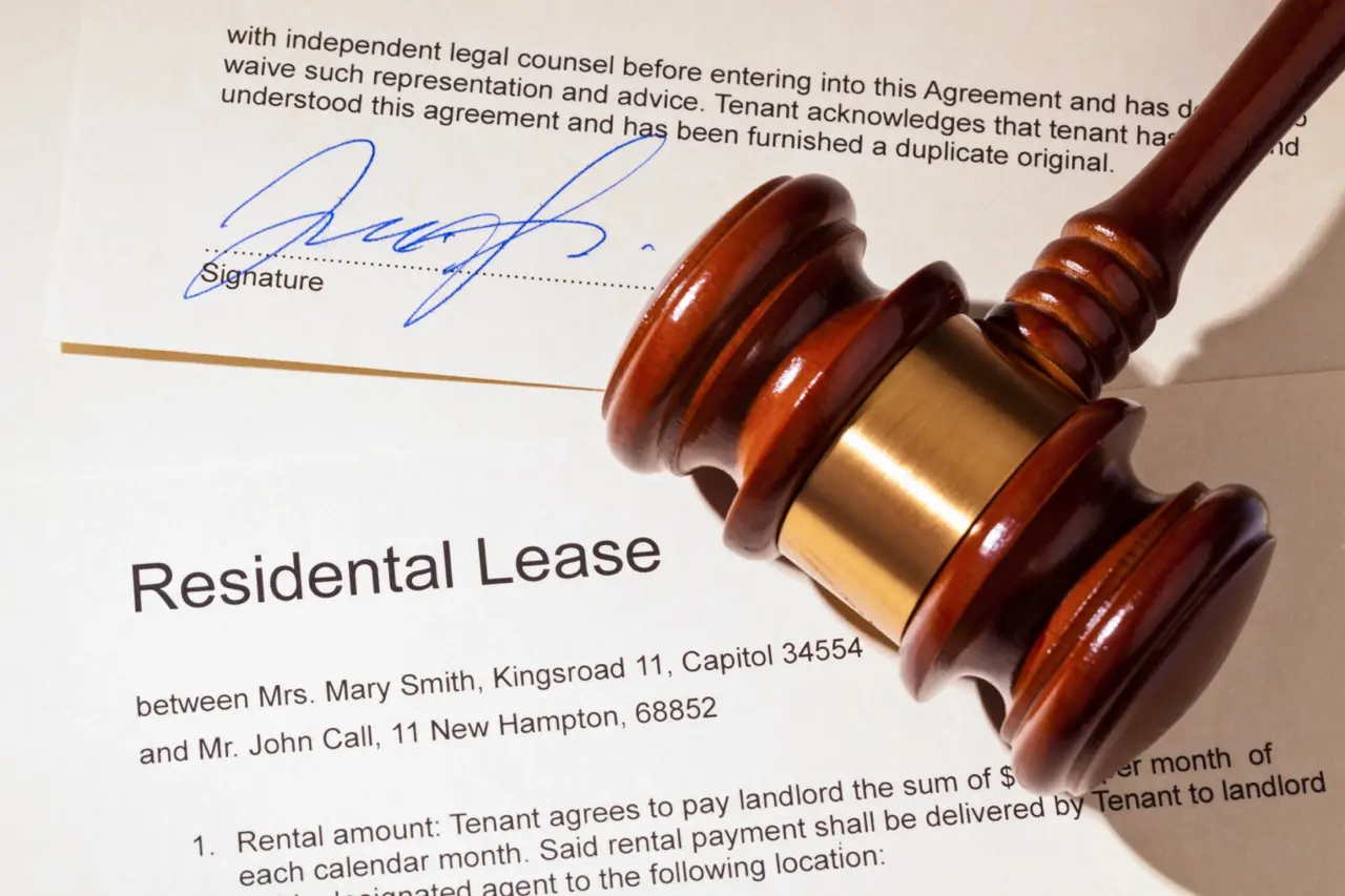 Signed residential lease agreement with gavel symbolizing legal enforcement