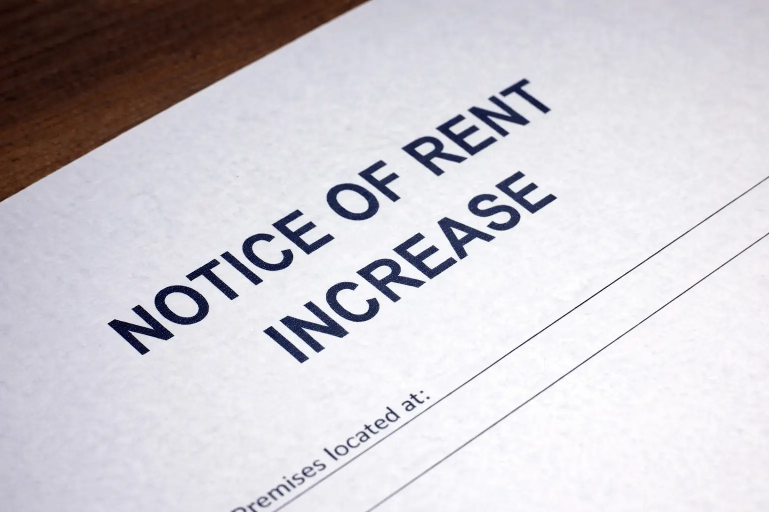 Notice of rent increase document showing written rental rate change on paper