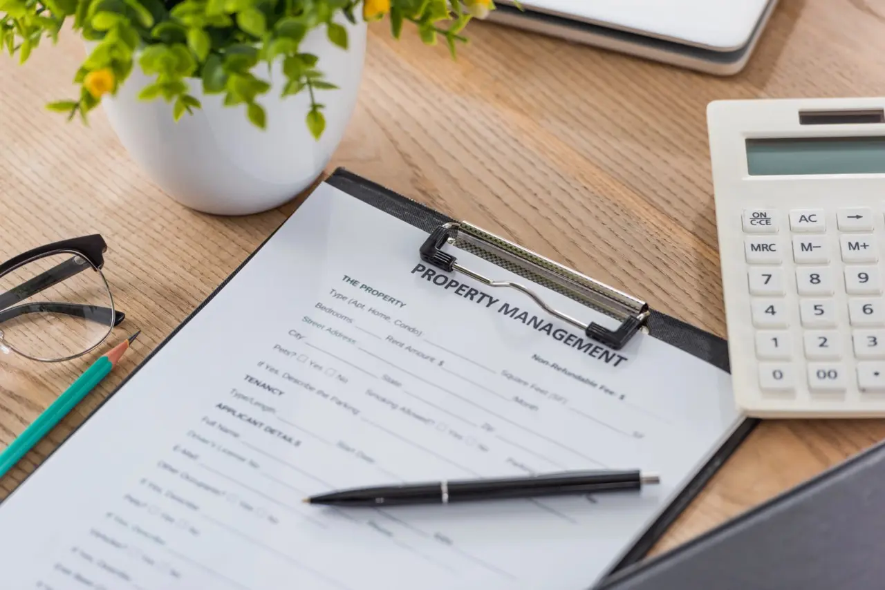 Property management contract and financial documents on a desk